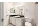 Bright bathroom featuring a granite countertop, white cabinets, and a large mirror at 3633 N 3Rd Ave # 2031, Phoenix, AZ 85013