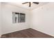 Bedroom featuring a ceiling fan, hardwood floors, and a large window at 3633 N 3Rd Ave # 2031, Phoenix, AZ 85013