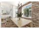 Cozy dining area with modern lighting, hardwood floors, and exposed brick accent wall at 3633 N 3Rd Ave # 2031, Phoenix, AZ 85013