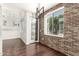 Bright dining room featuring a brick accent wall, modern lighting, and a balcony with a view at 3633 N 3Rd Ave # 2031, Phoenix, AZ 85013