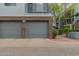 View of the two-car garages with brick and stone accents and pavers in the driveway at 3633 N 3Rd Ave # 2031, Phoenix, AZ 85013