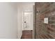 Hallway leading to the bathroom with brick wall accent at 3633 N 3Rd Ave # 2031, Phoenix, AZ 85013