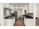Galley kitchen featuring white cabinetry, stainless steel appliances, granite countertops, and mosaic backsplash at 3633 N 3Rd Ave # 2031, Phoenix, AZ 85013