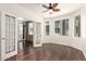 Sunlit living room featuring French doors, a ceiling fan, wood floors, and many large windows at 3633 N 3Rd Ave # 2031, Phoenix, AZ 85013