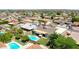 Aerial view of a home with a pool, covered patio, well-kept landscaping, and neighborhood at 3802 W Kelton Ln, Phoenix, AZ 85053