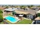 Backyard with a large pool, covered patio area with seating, and well-maintained lawn space at 3802 W Kelton Ln, Phoenix, AZ 85053
