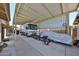 Large covered carport area with RV, scooters, and covered car, offering ample parking and protection at 3802 W Kelton Ln, Phoenix, AZ 85053