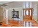 Foyer area boasts hardwood floors, a decorative cabinet, and a bright front entryway at 3802 W Kelton Ln, Phoenix, AZ 85053
