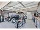 Spacious garage featuring epoxy floors, ample storage cabinets, and room for multiple vehicles and a motorcycle at 3802 W Kelton Ln, Phoenix, AZ 85053