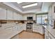 Bright kitchen featuring white cabinetry, tile floors and stainless steel appliances at 3802 W Kelton Ln, Phoenix, AZ 85053