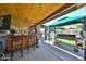 Outdoor bar area with wood ceiling, seating, grill, and view of the backyard at 3802 W Kelton Ln, Phoenix, AZ 85053