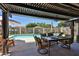 Inviting outdoor living area with a covered patio, pool view, and stylish patio furniture for entertaining at 3802 W Kelton Ln, Phoenix, AZ 85053
