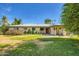 A wide back exterior with a covered patio and expansive yard, perfect for outdoor living and relaxation at 3944 E Oak St, Phoenix, AZ 85008