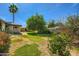 Expansive backyard with mature tree offers ample shade; a tranquil space for outdoor enjoyment and relaxation at 3944 E Oak St, Phoenix, AZ 85008