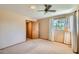 Bright bedroom featuring neutral tones, a ceiling fan, and a window with natural light and backyard views at 3944 E Oak St, Phoenix, AZ 85008