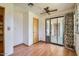 Bonus room featuring beautiful laminate flooring, fan, natural light, and backyard access at 3944 E Oak St, Phoenix, AZ 85008