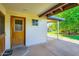 Inviting covered entryway features a classic wooden door and neutral color palette, enhancing curb appeal at 3944 E Oak St, Phoenix, AZ 85008