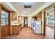 Well-lit kitchen featuring white appliances, wood cabinets, and wood laminate flooring at 3944 E Oak St, Phoenix, AZ 85008