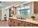 Traditional kitchen featuring wood cabinets, laminate countertops, and a large window at 3944 E Oak St, Phoenix, AZ 85008