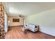 Inviting living room with wood laminate floors, a comfortable couch, and a vintage ceiling fan at 3944 E Oak St, Phoenix, AZ 85008