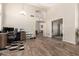 Spacious living room featuring hardwood floors, a large workspace, and a chandelier at 4137 E Stanford Ave, Gilbert, AZ 85234