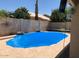 Backyard pool featuring a bright blue pool cover, surrounded by a block wall and desert landscaping at 4137 E Stanford Ave, Gilbert, AZ 85234