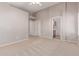 Bedroom with neutral carpet, light walls, and an open doorway to a bathroom at 42551 W Anne Ln, Maricopa, AZ 85138