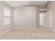 Bedroom with neutral carpet, light walls, and two doors leading to other rooms at 42551 W Anne Ln, Maricopa, AZ 85138