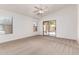 Spacious bedroom with neutral carpet, ceiling fan, and sliding door to the backyard at 42551 W Anne Ln, Maricopa, AZ 85138