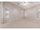 Spacious bedroom with neutral carpet, light walls, ceiling fan and window with blinds at 42551 W Anne Ln, Maricopa, AZ 85138