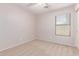 Bedroom featuring a neutral paint and carpet, and a large window at 42551 W Anne Ln, Maricopa, AZ 85138