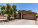 Charming single-story home features a two-car garage, neutral stucco, and low maintenance desert landscaping at 42551 W Anne Ln, Maricopa, AZ 85138