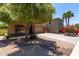 Attractive single-Gathering home featuring a lush front yard, mature trees, and a long driveway leading to a two-car garage at 42551 W Anne Ln, Maricopa, AZ 85138