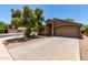 Inviting single-Gathering home featuring lush landscaping, a mature shade tree, and an attached two-car garage at 42551 W Anne Ln, Maricopa, AZ 85138