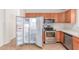 Open refrigerator showcasing the interior, alongside stainless appliances at 42551 W Anne Ln, Maricopa, AZ 85138