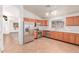 Open kitchen layout with stainless steel appliances and tiled flooring at 42551 W Anne Ln, Maricopa, AZ 85138