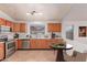 Cozy kitchen with stainless steel appliances, wood cabinets, and a breakfast nook at 42551 W Anne Ln, Maricopa, AZ 85138
