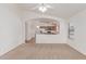 Bright living space leading into a kitchen with stainless appliances at 42551 W Anne Ln, Maricopa, AZ 85138