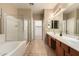 A spacious bathroom with double sinks, a soaking tub, and a separate shower with a glass door at 44517 W Copper Trl, Maricopa, AZ 85139