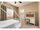 Cozy bedroom featuring a window, a house frame bed, a desk with a chair, and neutral tones at 44517 W Copper Trl, Maricopa, AZ 85139