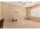 Carpeted bedroom with neutral walls, a window with blinds, and two side tables at 44517 W Copper Trl, Maricopa, AZ 85139