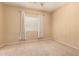 Bedroom featuring a window with curtains, carpet flooring, and neutral walls and tones at 44517 W Copper Trl, Maricopa, AZ 85139