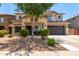 Inviting two-story home featuring a well-maintained front yard with desert landscaping and a spacious two-car garage at 44517 W Copper Trl, Maricopa, AZ 85139