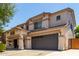 Two-story home featuring a spacious two-car garage, covered entry and neutral color palette at 44517 W Copper Trl, Maricopa, AZ 85139