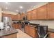 A well-lit kitchen featuring stainless steel appliances, a breakfast bar, and plenty of cabinet space at 44517 W Copper Trl, Maricopa, AZ 85139