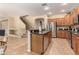 A spacious kitchen featuring stainless steel appliances, granite countertops, and an island at 44517 W Copper Trl, Maricopa, AZ 85139