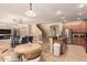 Open concept living and dining area with tile flooring, stainless steel appliances, and ample counter space at 44517 W Copper Trl, Maricopa, AZ 85139