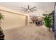 Spacious living area with carpet, ceiling fan and open floor plan to dining and kitchen area at 44517 W Copper Trl, Maricopa, AZ 85139