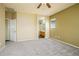 Spacious bedroom with neutral carpet and access to an en-suite bathroom provides a calm, inviting space at 45391 W Portabello Rd, Maricopa, AZ 85139