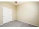 Empty bedroom featuring neutral walls, carpet flooring, and a double door closet at 45391 W Portabello Rd, Maricopa, AZ 85139